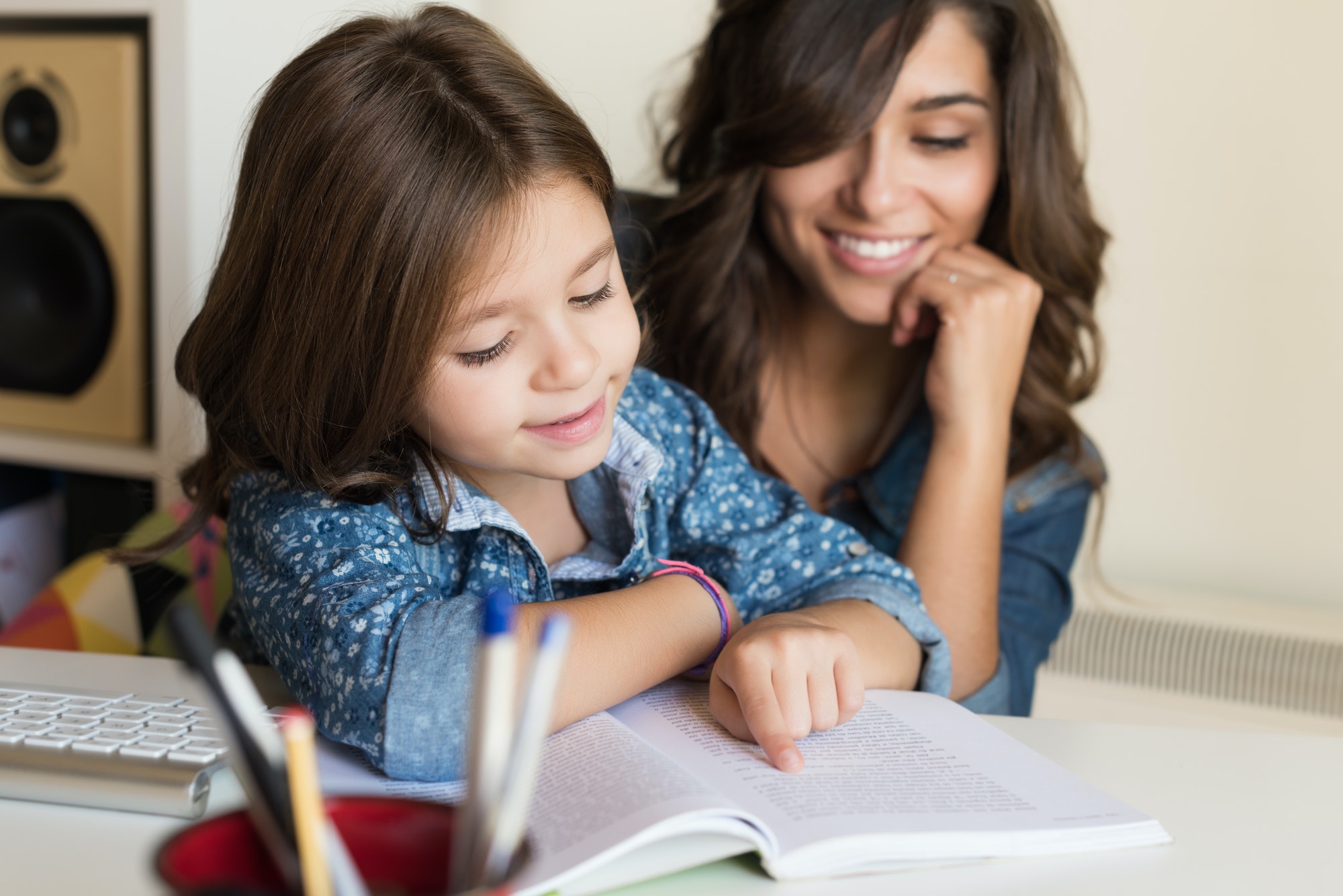 Mother helping child with homework